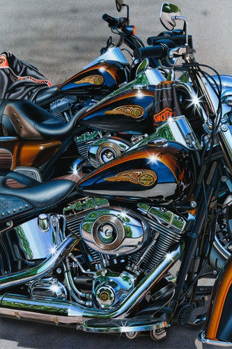 Three Harley Davidson motorcycles in colors of chrome, orange and gold.