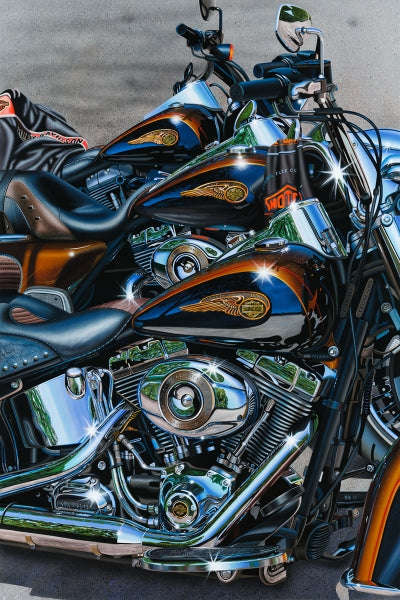 Three Harley Davidson motorcycles in colors of chrome, orange and gold.