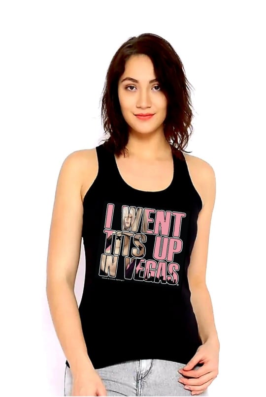 Women's black tank top with "I WENT TITS UP IN VEGAS" in pink lettering. Inside the lettering is a blonde woman wearing nothing but black pants, black sleeves, and black tape in the shape of an "X" on her nipples. Rated Adult. 