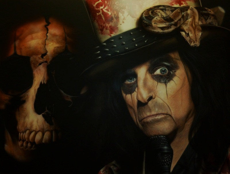 Alice Cooper is pictured holding a microphone. He is wearing black face paint around his eyes and a bloodstained-looking spiked top hat with a patterned large snake on the side of it. In the background on the left is a slightly faded cracked scull.