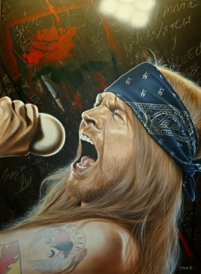 Axl Rose is pictured with eyes closed, screaming into a microphone in his hand. He wears a blue bandana around his long blond hair and his tattooed arms are bare. There's a brown background with various unintelligible writings and a red painted rose.  